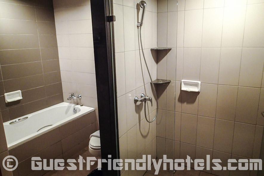 Bathroom is clean with a seperate walk-in shower and a bathtub in Sea Me Spring Hotel