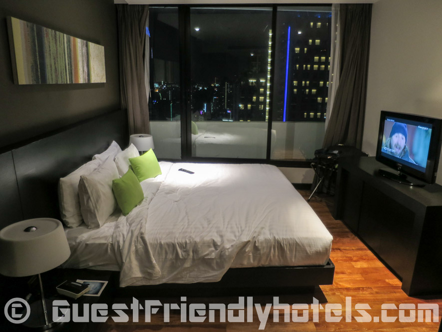 Bedroom wirth TV and view over Sukhumvit skyline at the Fraser Suites Bangkok