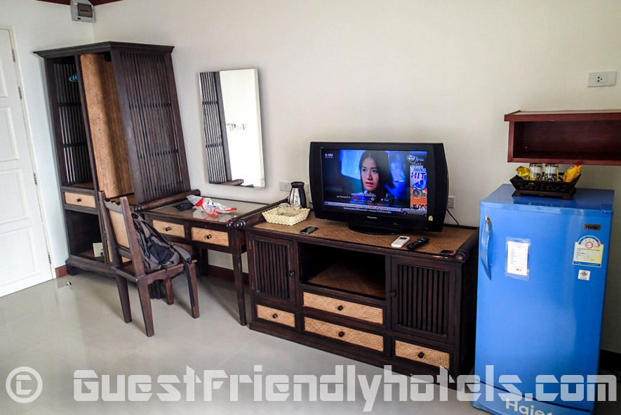 View of room amenities that include open wardrobe and TV in Baan Sila Pattaya