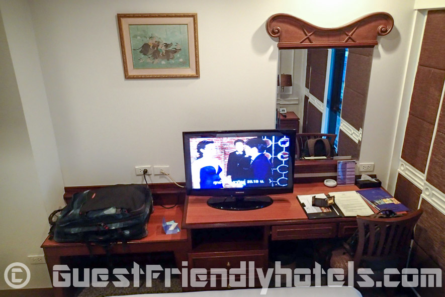 Samsung Flatscreen and desk opposite bed in Majestic Suite Hotel -Superior Queensize room