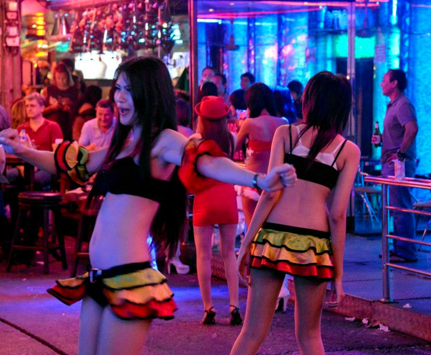 bargirls attracting customers inside bars of soi cowboy