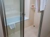 Glass door leading to tub and shower