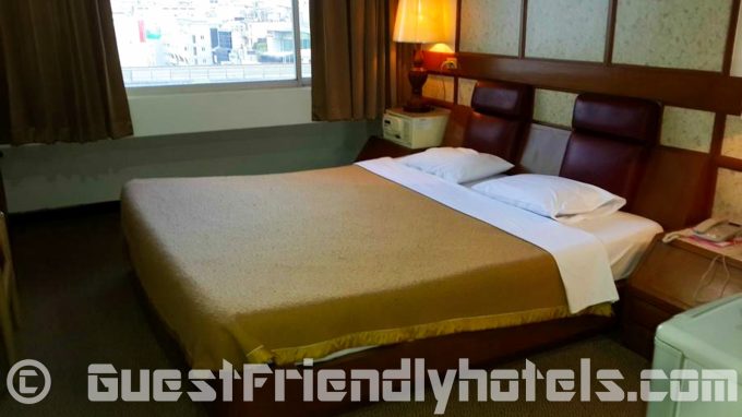 Standard room bed at Nana Hotel